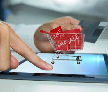 Composite image of hand using tablet computer for  buy with the credit card