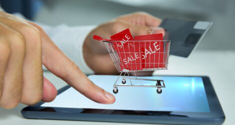 Composite image of hand using tablet computer for  buy with the credit card