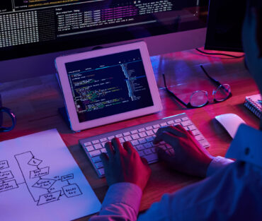 Programmer working at IT company office late at night